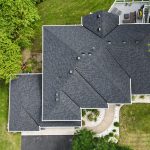 Aerial drone view of completed roof replacement on Maple Grove Minnesota home with new Owens Corning Duration shingles in Onyx Black installed by First Impressions Exteriors