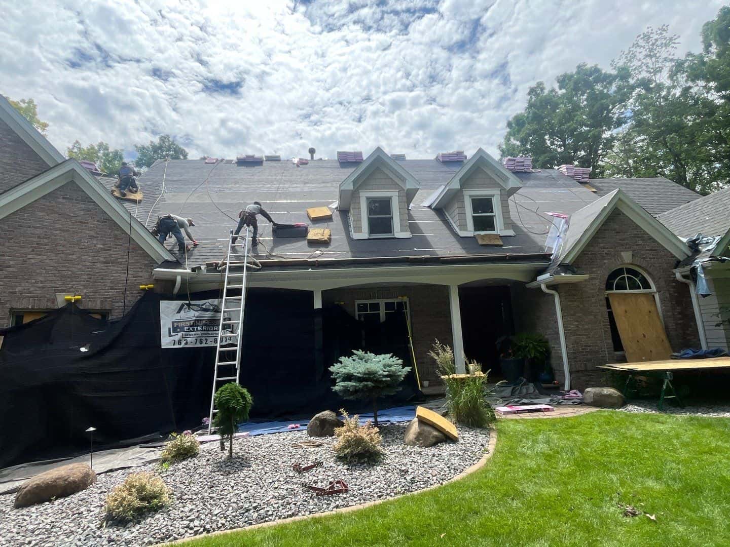 Hail damage repair Twin Cities – First Impressions Exteriors completing roof and gutter replacement on Plymouth Minnesota home following insurance-approved hail damage claim