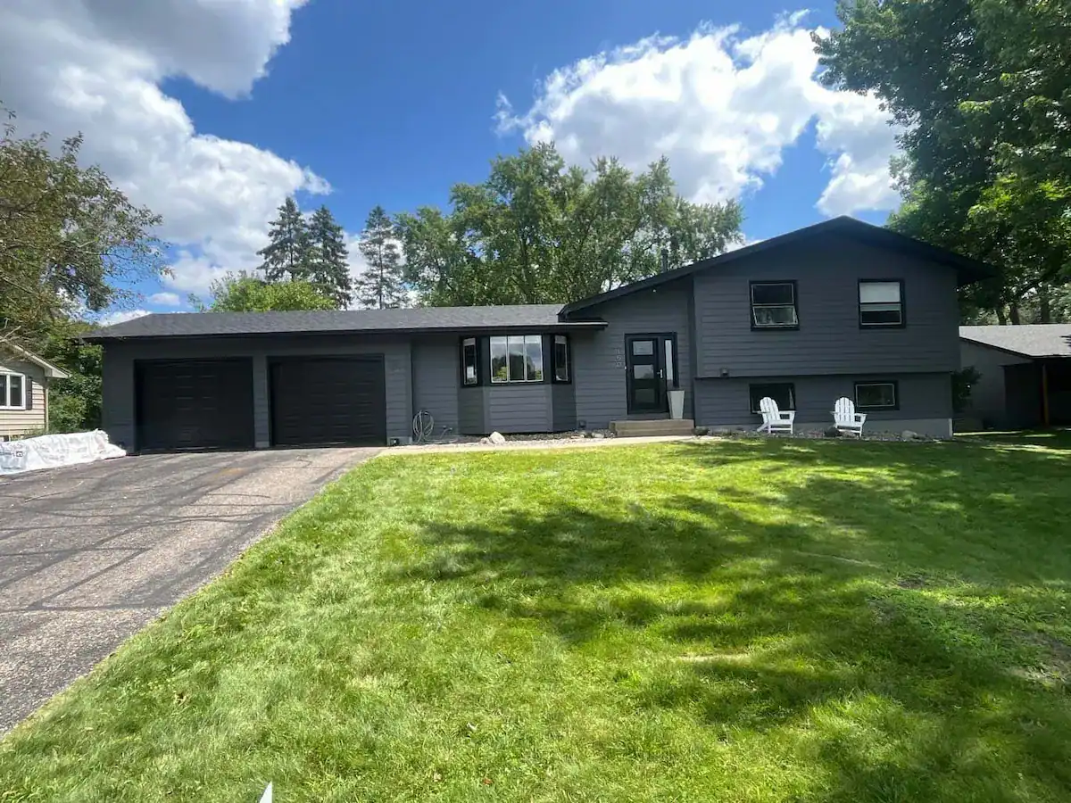 After photo of split-level Golden Valley Minnesota home with new charcoal gray LP SmartSide lap siding and black Owens Corning asphalt shingle roof installed by First Impressions Exteriors