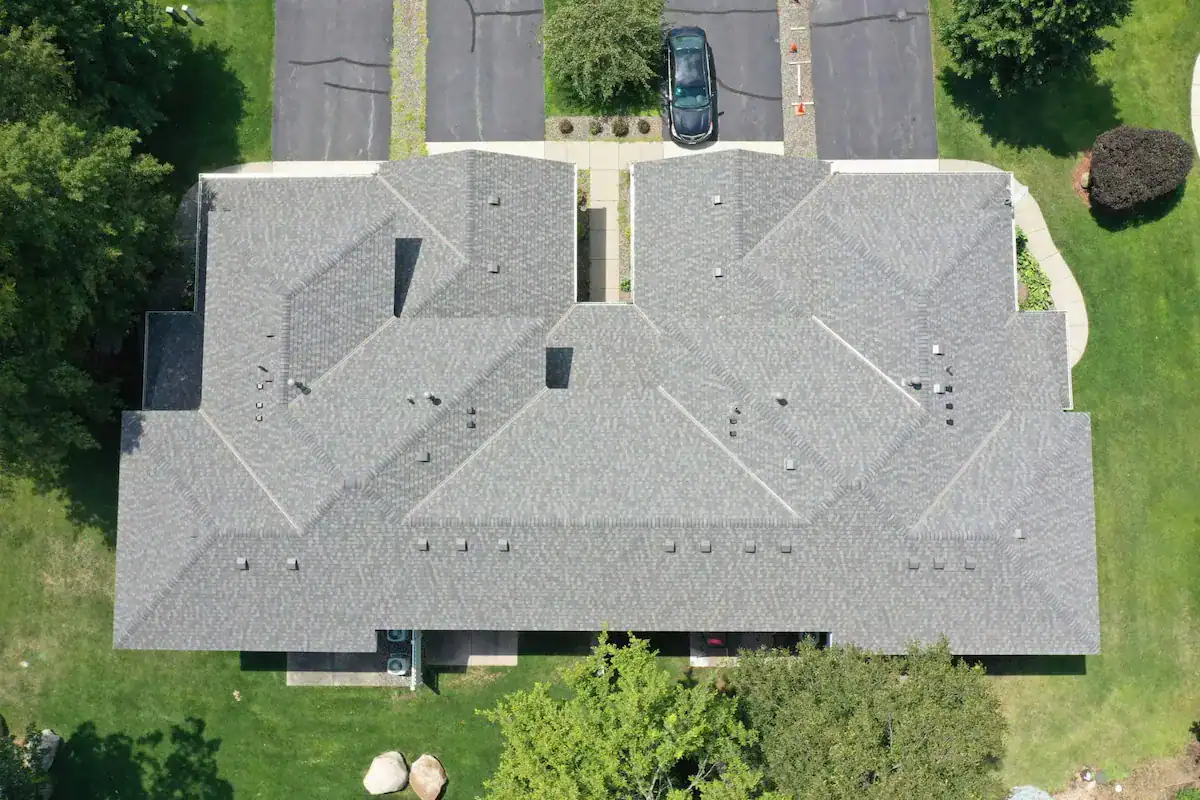 Aerial view of completed Twin Cities roofing project showing townhome with new architectural shingles installed by First Impressions Exteriors