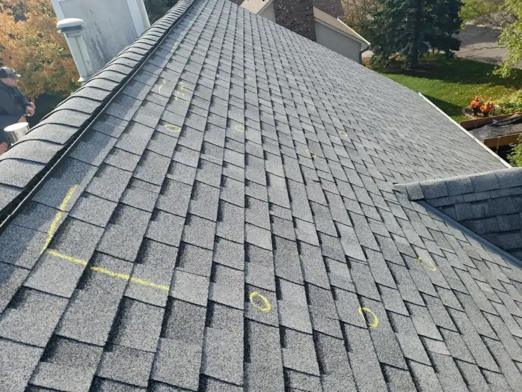 Hail damage test square marked for insurance adjuster inspection on a roof in Plymouth, MN by First Impressions Exteriors