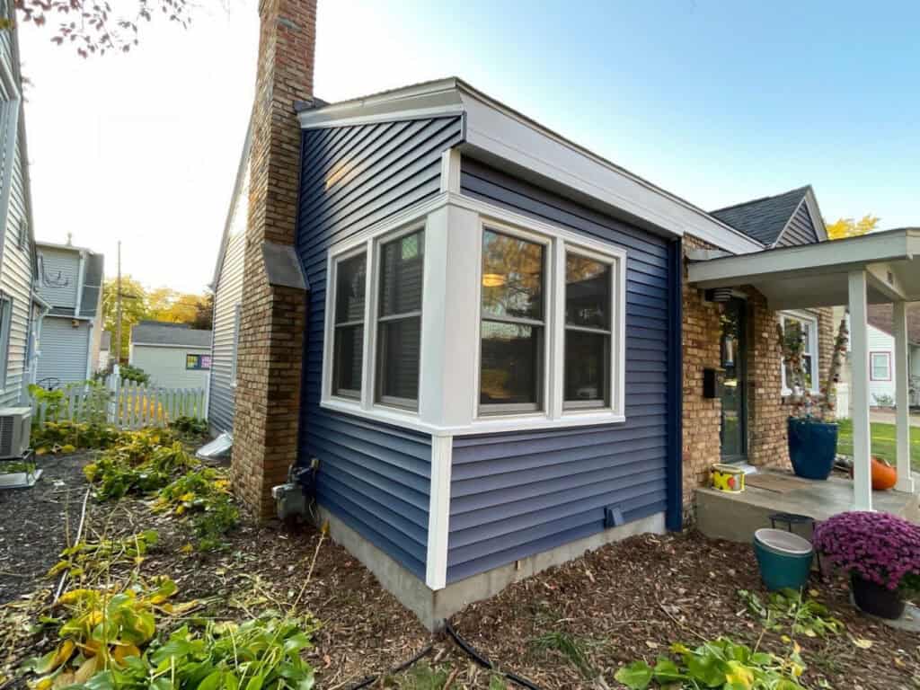 New navy vinyl siding and bay window installed on a St. Louis Park home by First Impressions Exteriors