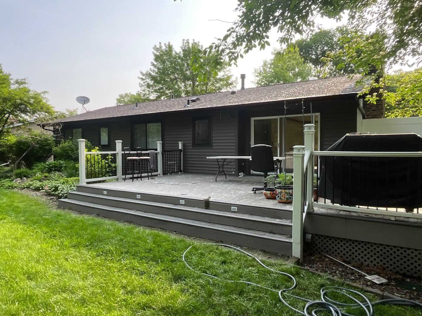 Burnsville, MN home after an Alside Charter Oak siding remodel in Smoke with new deck