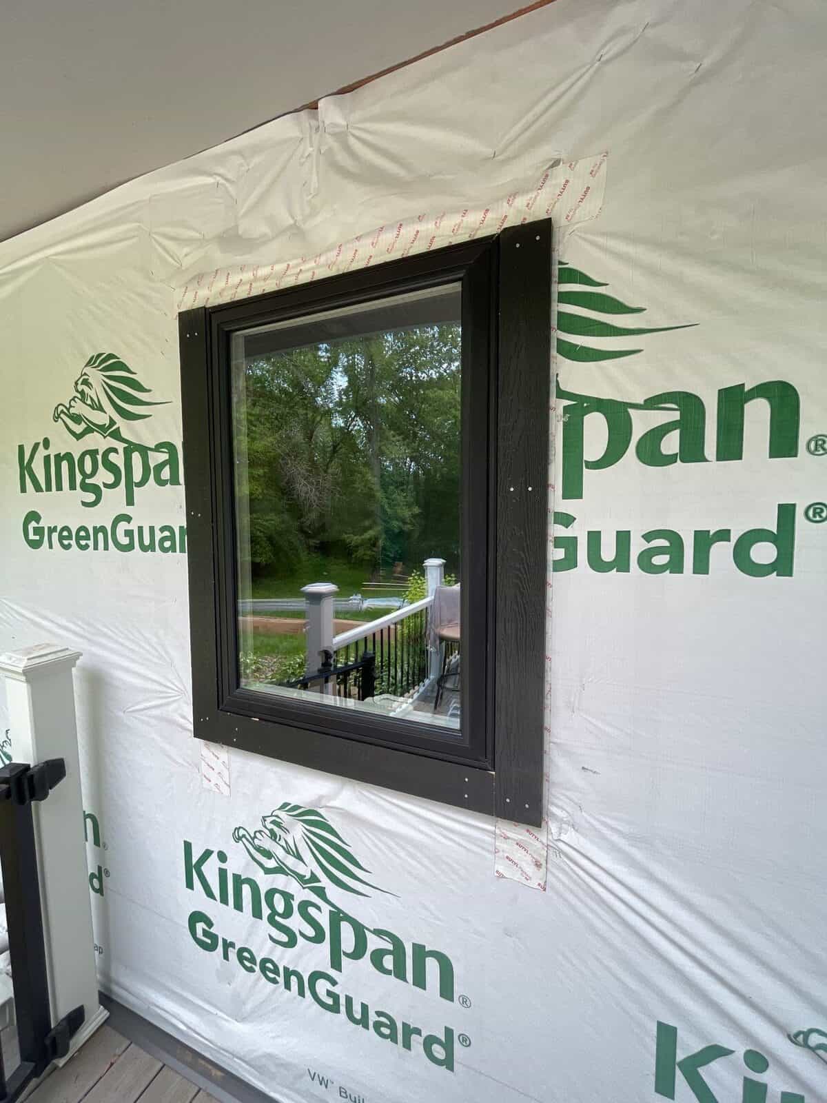 Hayfield black frame window set in weather-resistant wrap during a Burnsville, MN remodel