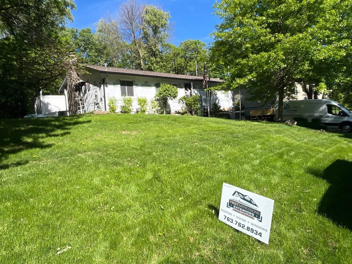 Completed Burnsville, MN exterior remodel with First Impressions Exteriors yard sign