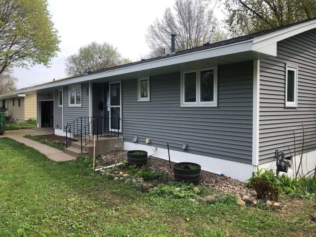 Crystal, MN home with new Mastic Carvedwood siding in Deep Granite and an Owens Corning Duration roof in Onyx Black