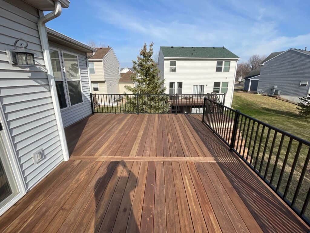 Maple Grove, MN deck with a new surface and black aluminum railings