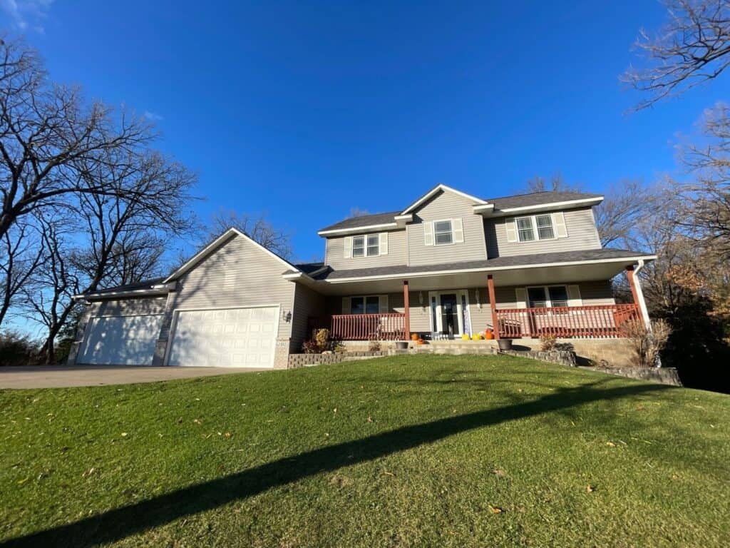 Oak Grove, MN home with a new Owens Corning Duration roof in Midnight Plum and Mastic Carvedwood siding in Harbor Grey