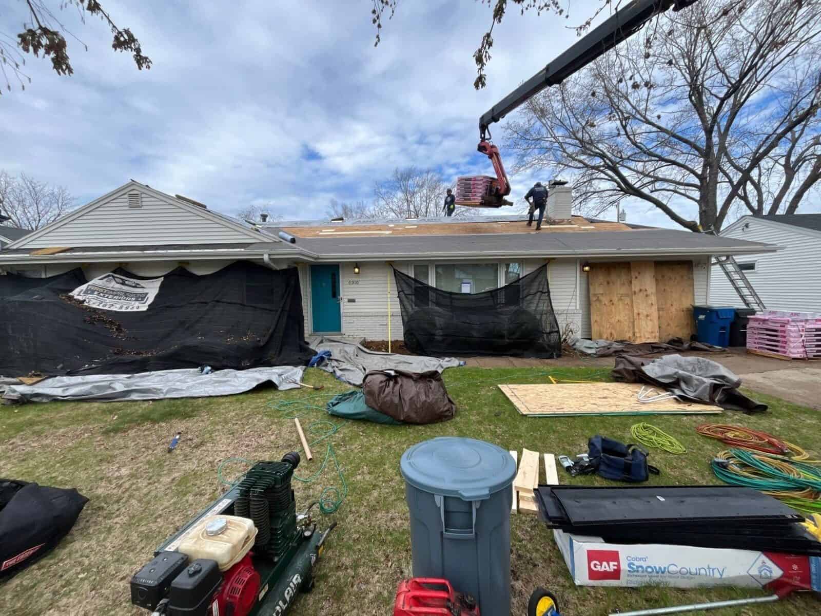 Tarps protecting a Minneapolis, MN home during a roof tear-off