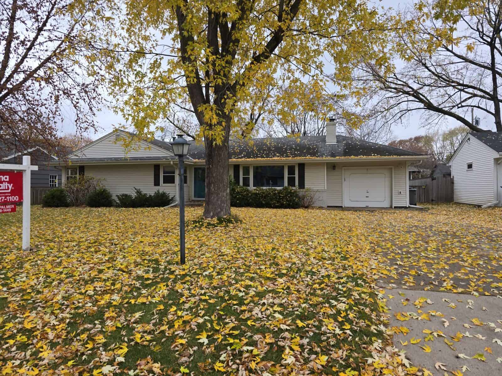 Minneapolis, MN home before its roof replacement, with a for-sale sign in the yard