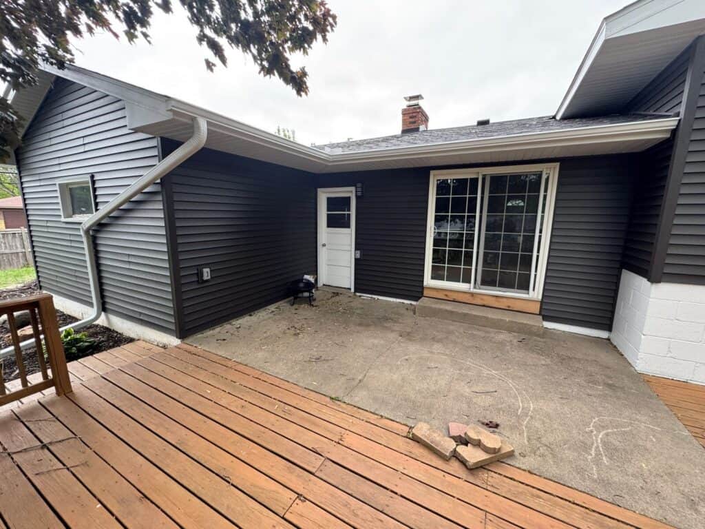 New Hope, MN home after a full exterior restoration with CertainTeed Restoration Classic siding in Slate and an Owens Corning Duration roof in Onyx Black