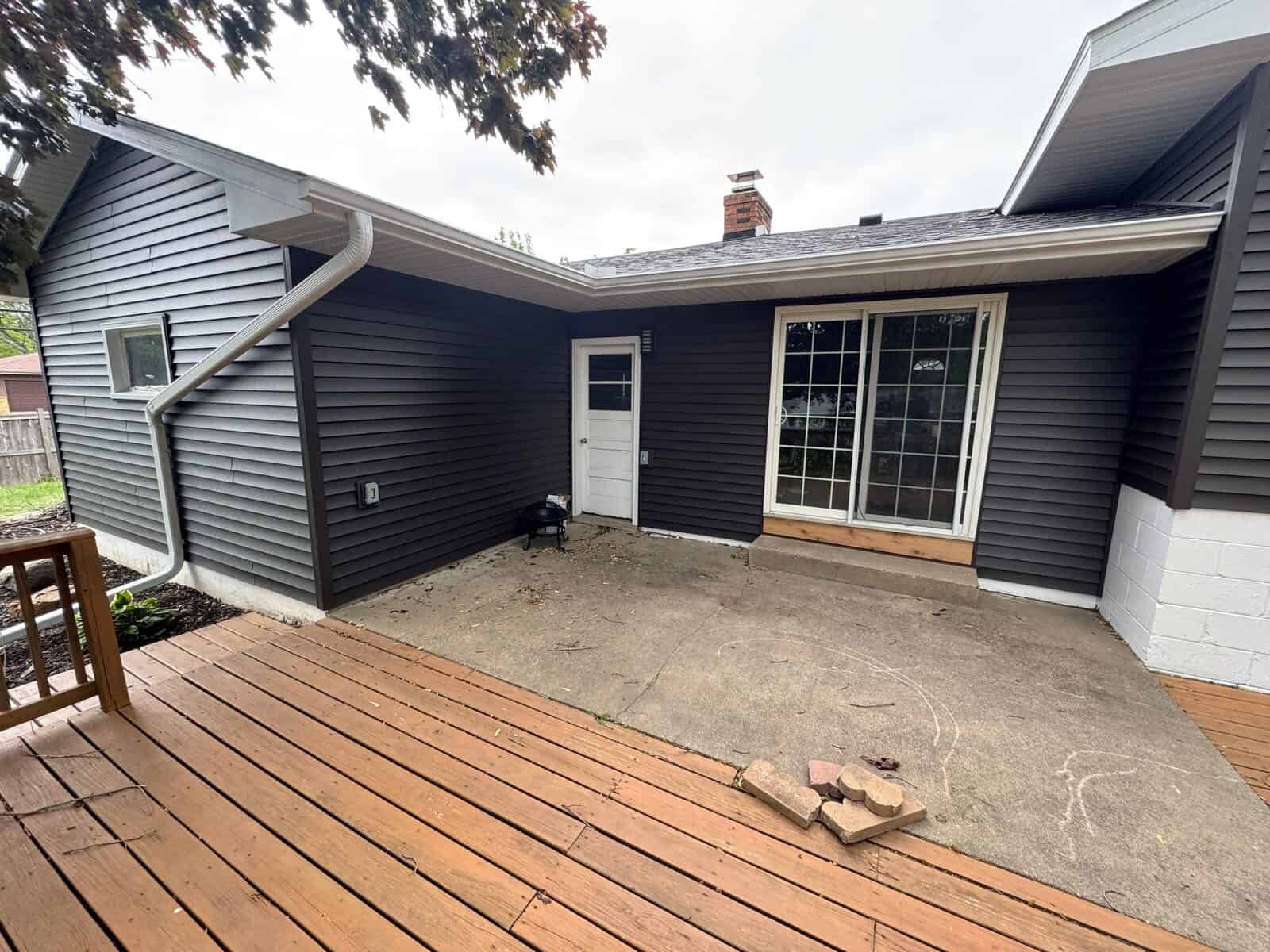 New Hope, MN home after a full exterior restoration with CertainTeed Restoration Classic siding in Slate and an Owens Corning Duration roof in Onyx Black