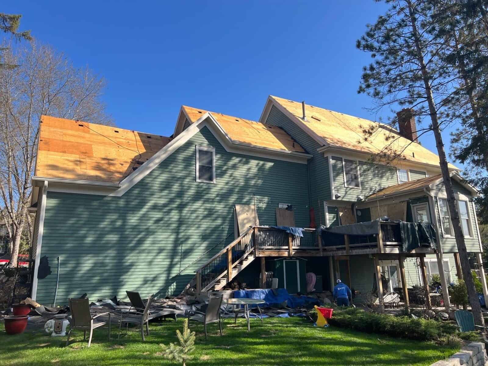 Tear-off in progress on a steep roof in Woodbury, MN