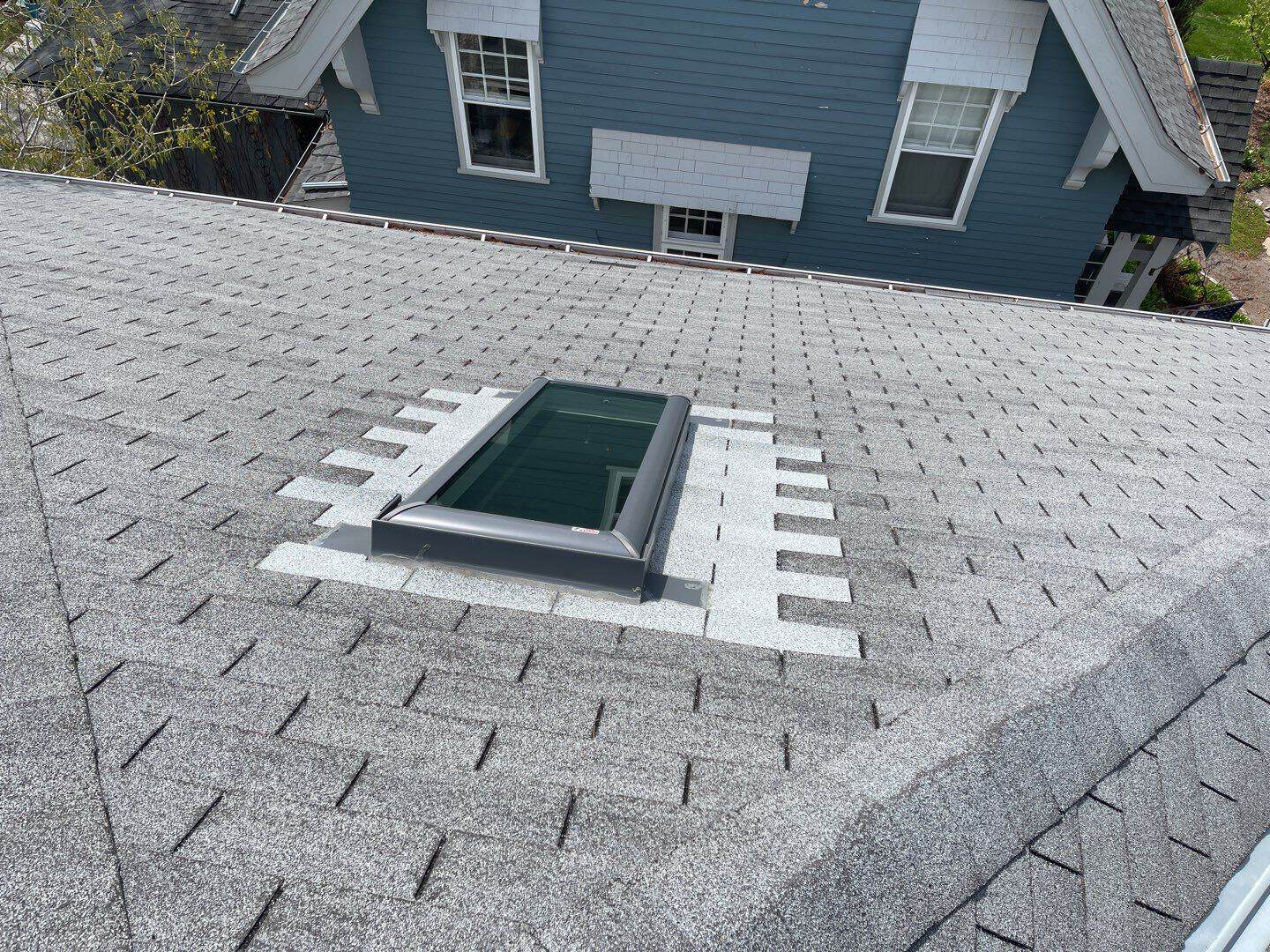 New Velux skylight set into a new GAF Timberline HDZ roof in Charcoal on a Minneapolis, MN home