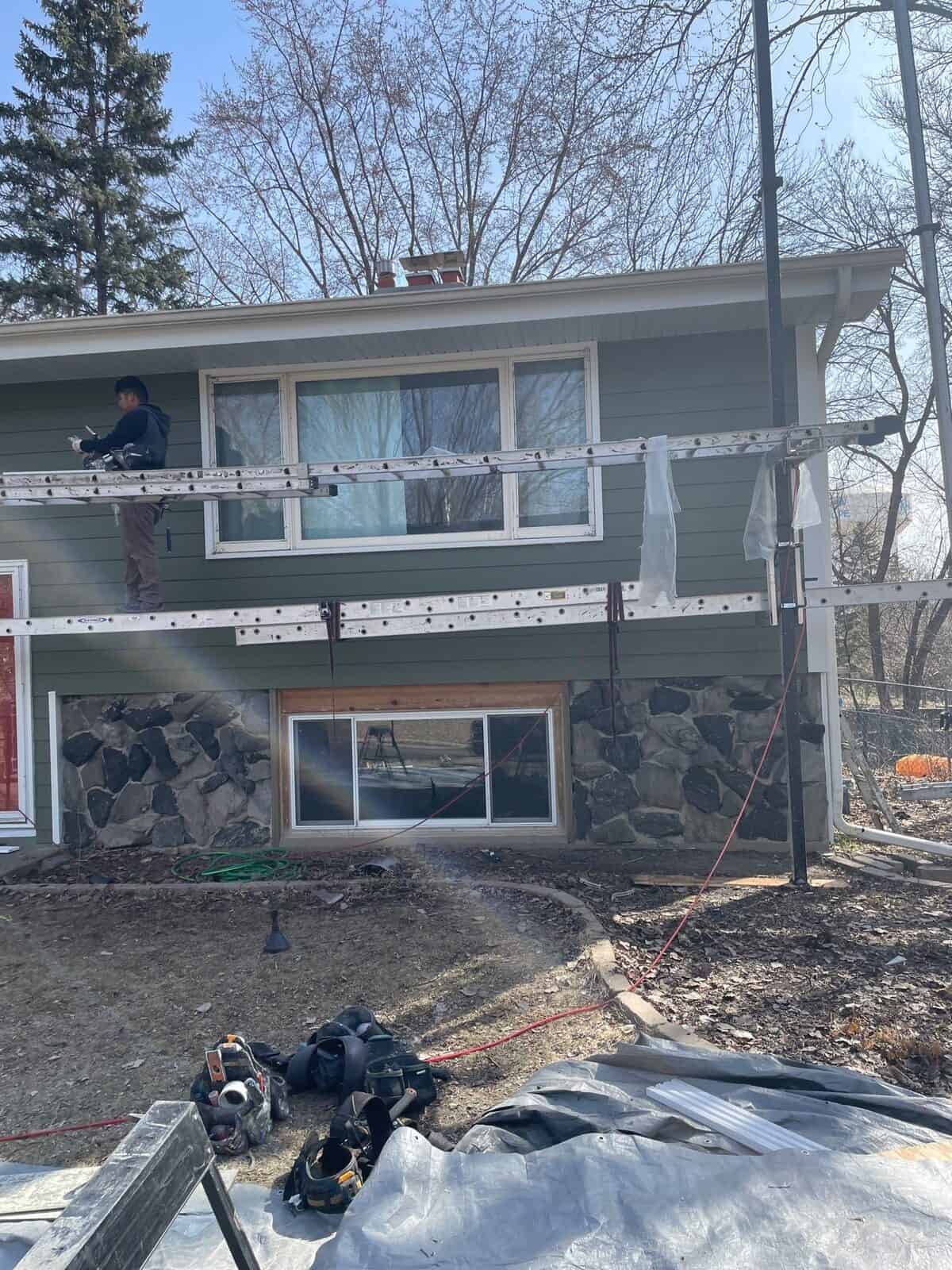 Detail of new siding and Polar White fascia around stone accents in Plymouth, MN