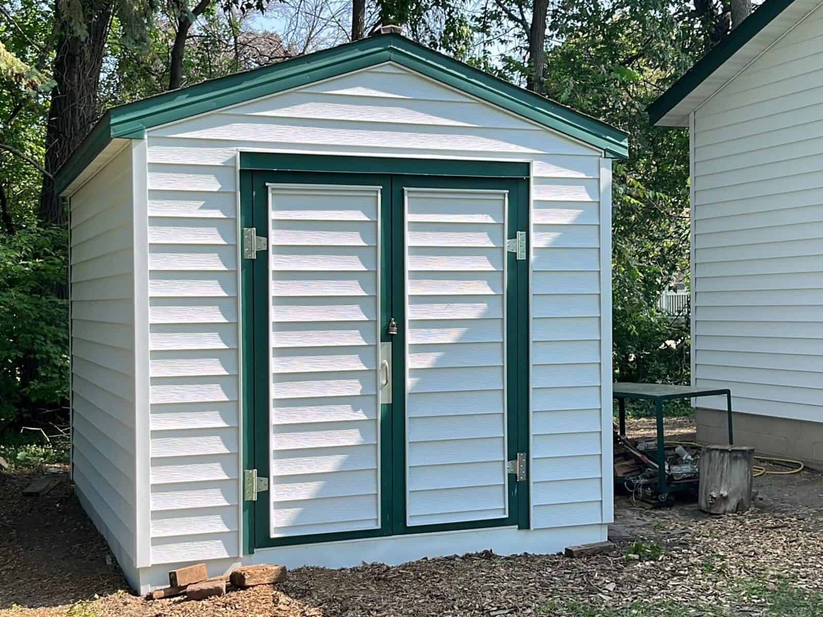 Shed with new Glacier White siding and green trim in Little Canada, MN