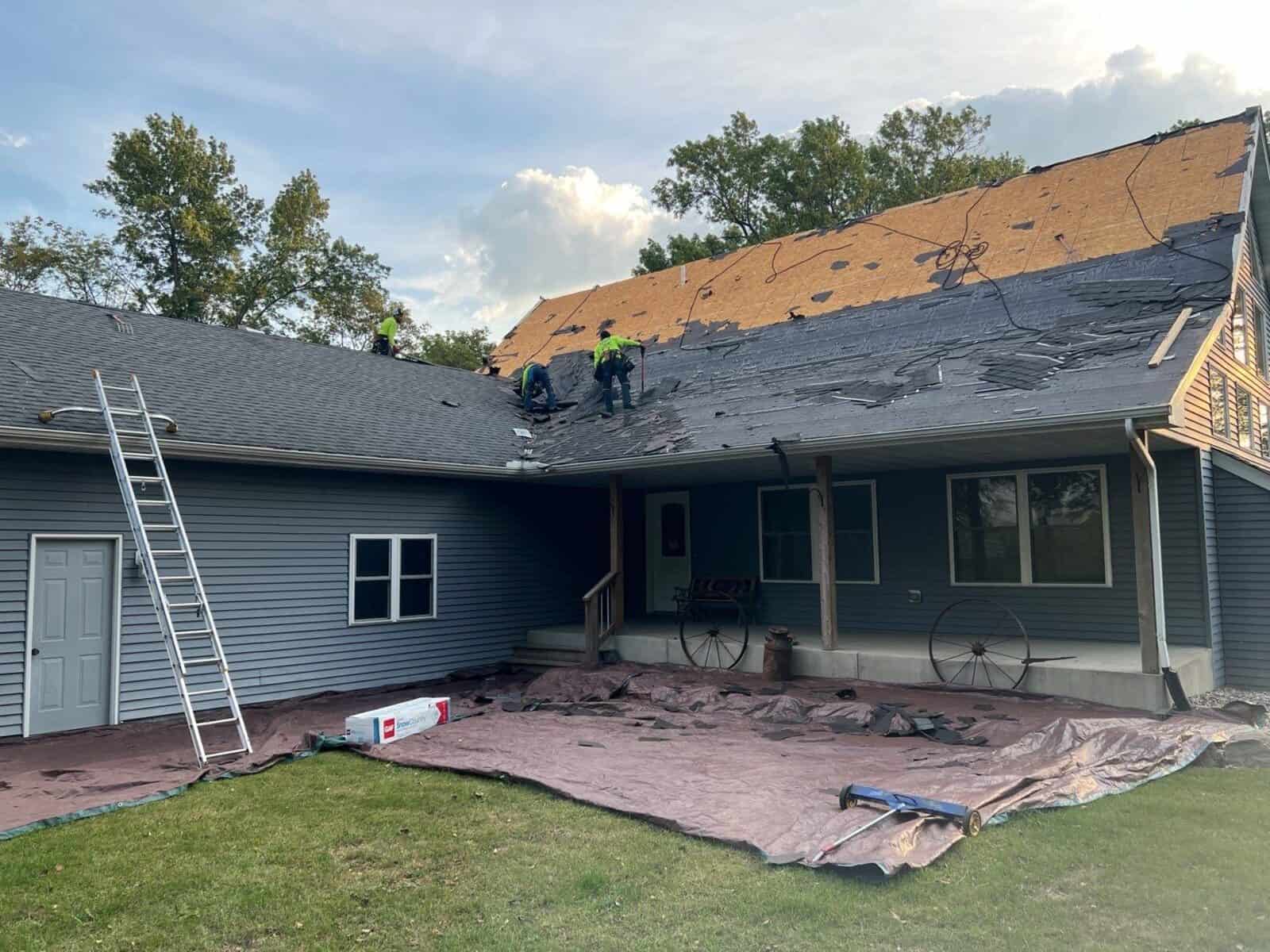 Roof tear-off in progress on an Annandale, MN home with the yard protected