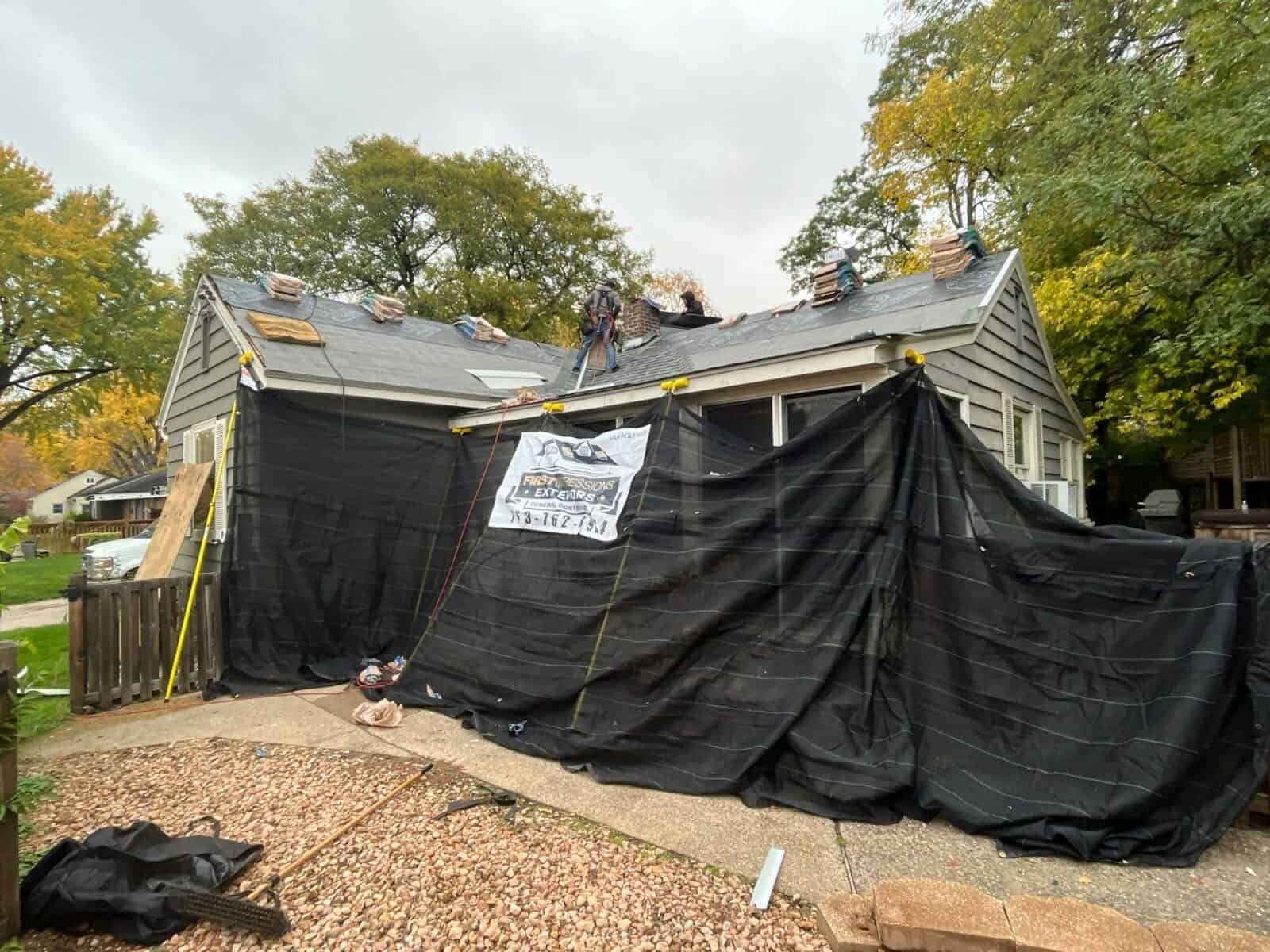 Home protected with tarps during a roof replacement in Golden Valley, MN