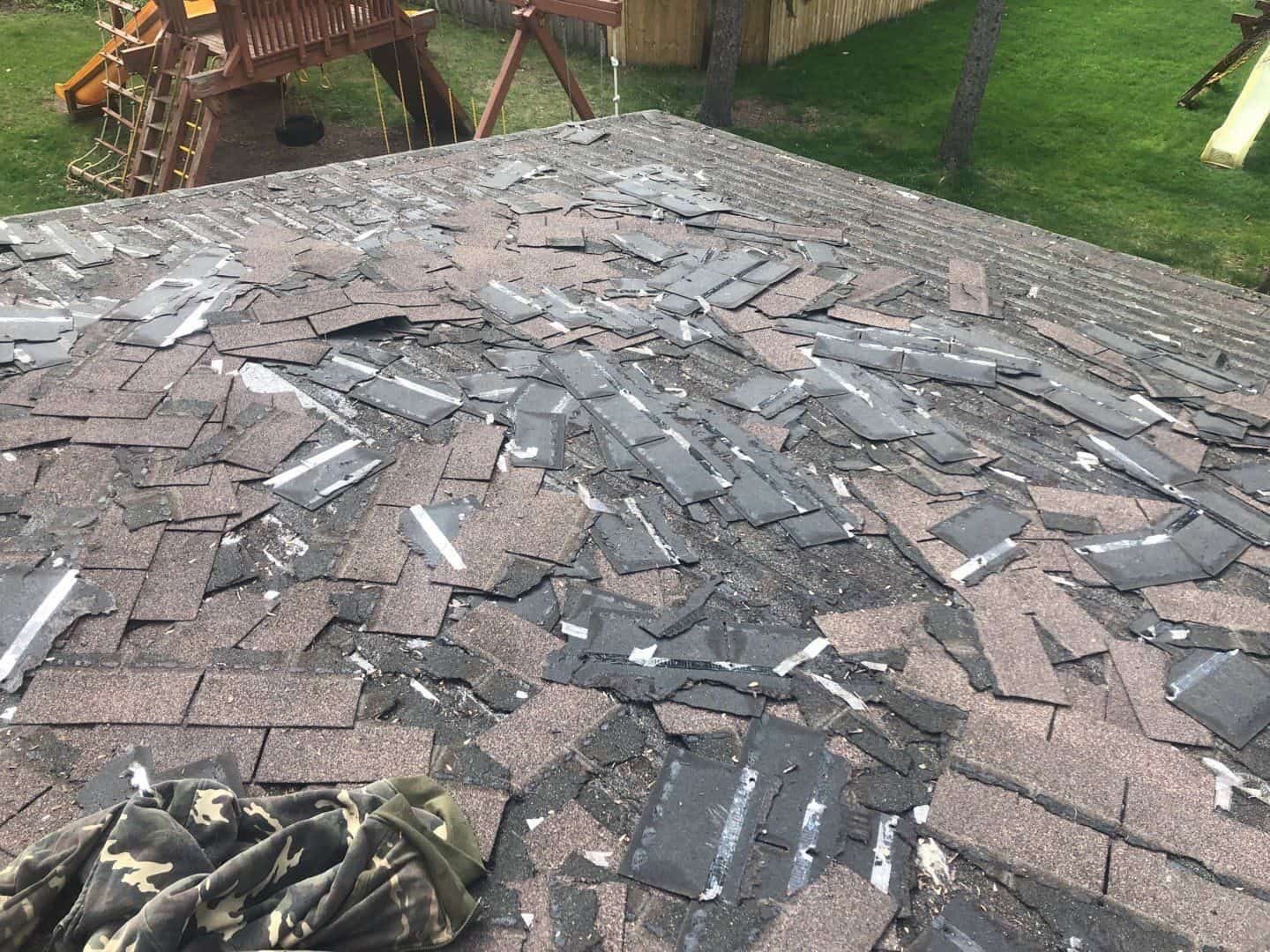 Old hail-damaged shingles removed down to the decking on a Minnetonka, MN roof