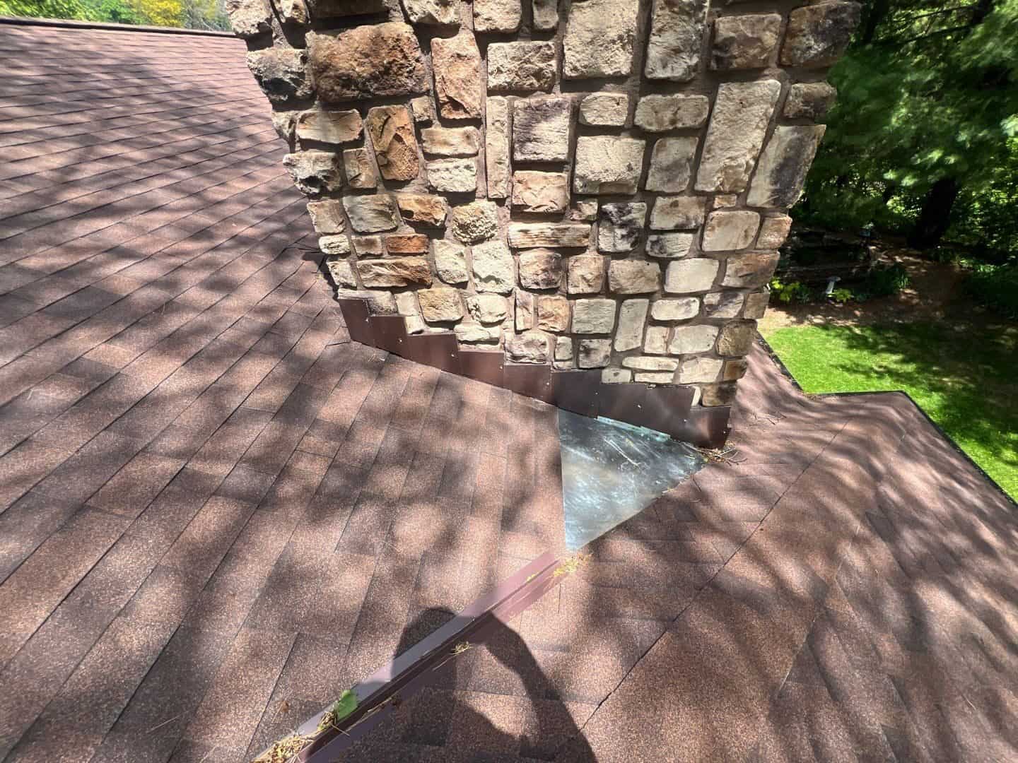 Custom-fabricated chimney flashing on a Bloomington, MN roof replacement