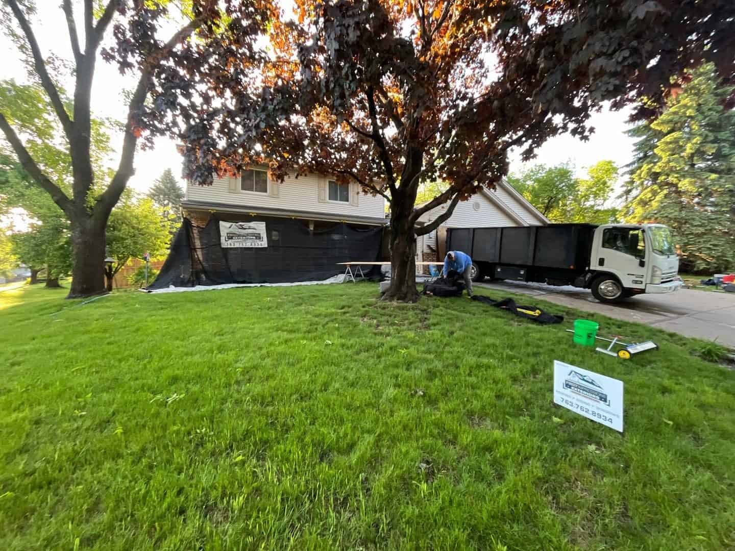 First Impressions Exteriors yard sign at a finished Plymouth, MN roof replacement