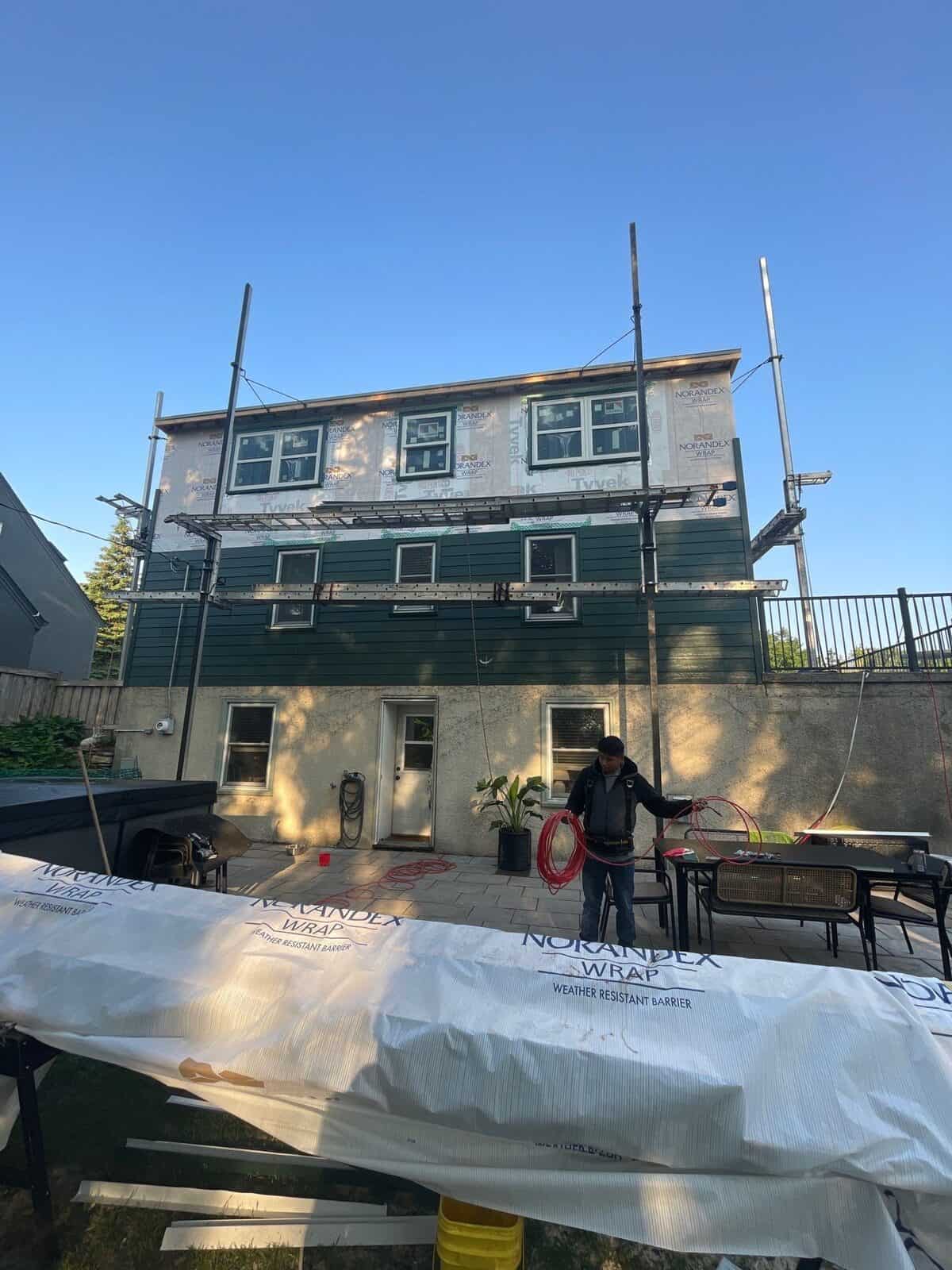 Siding installation in progress with weather-resistant wrap in St. Louis Park, MN