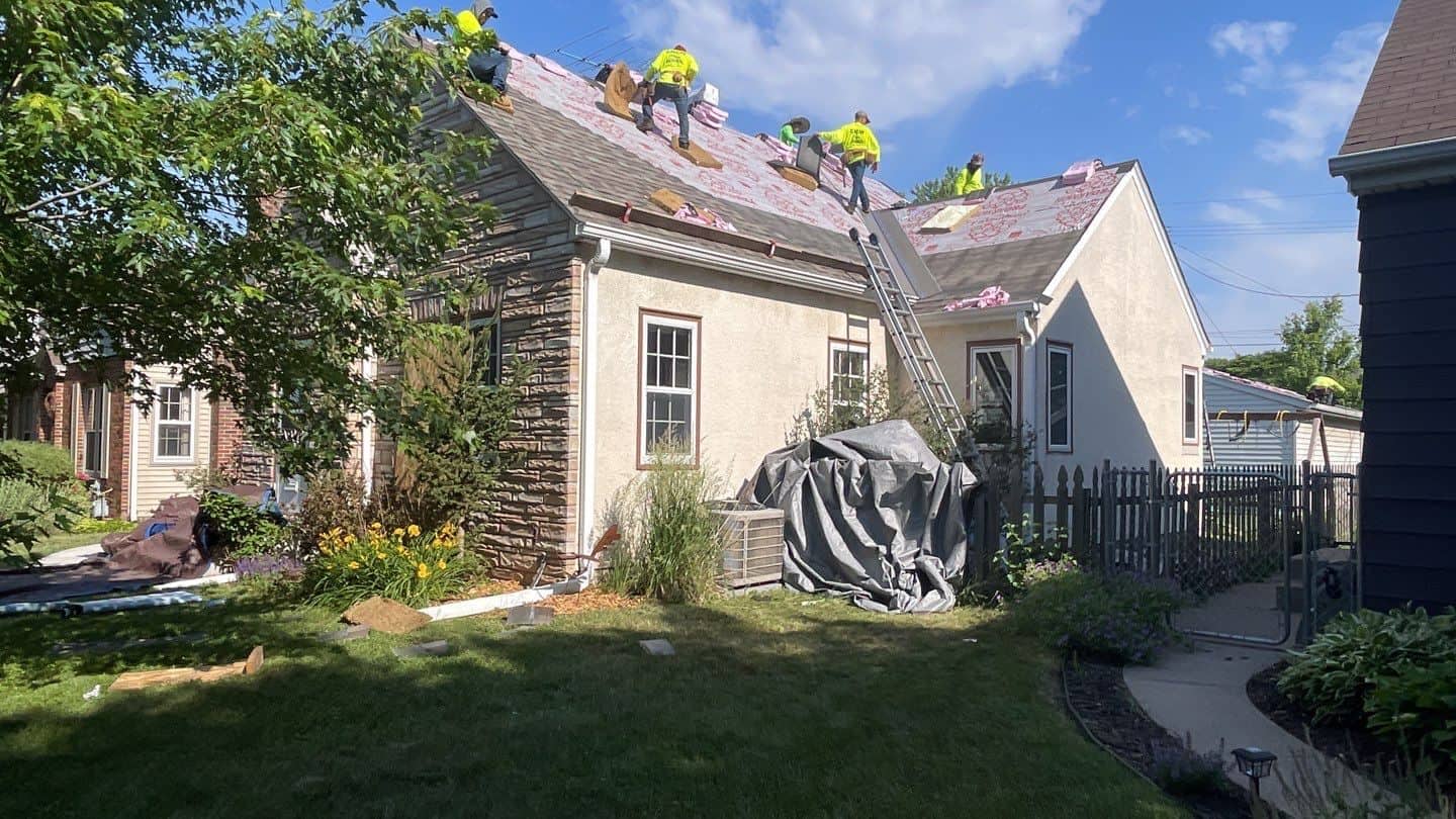 The crew at work on the steep slopes of a St. Paul, MN re-roof
