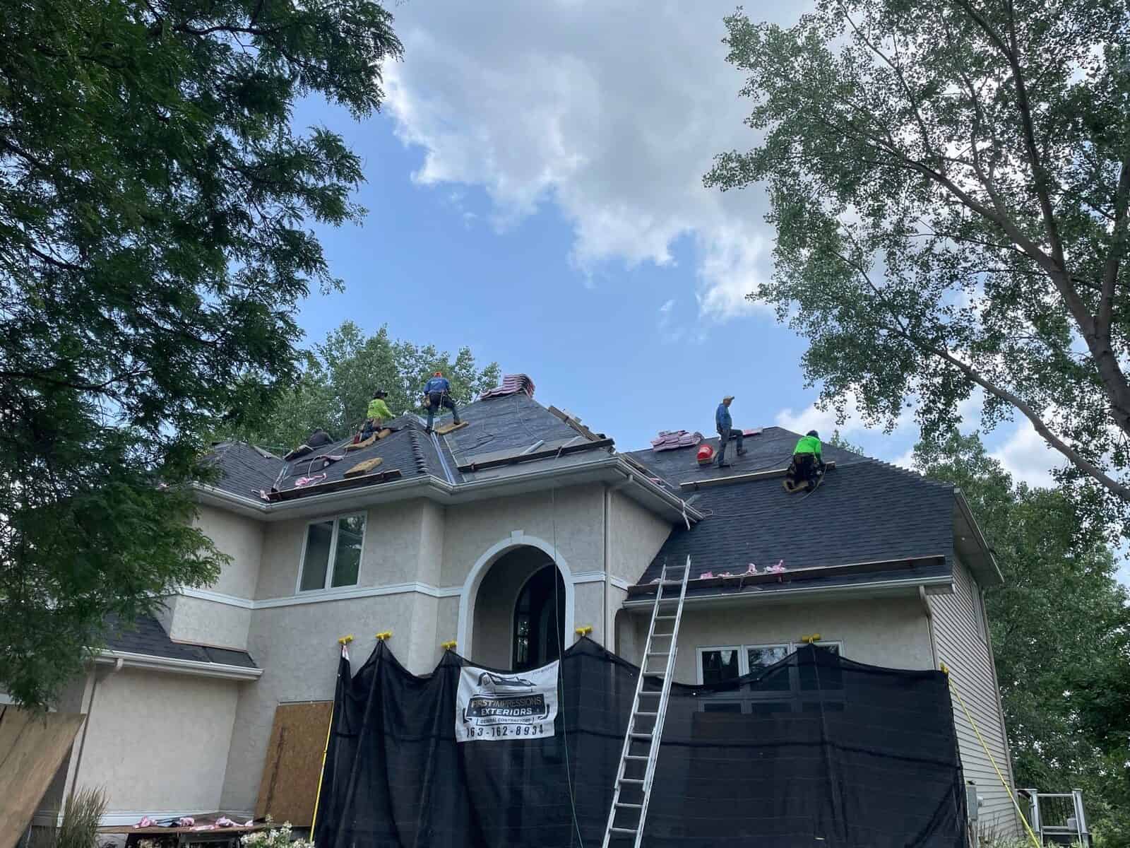 Entry protected with tarps during a Plymouth, MN roof and gutter replacement