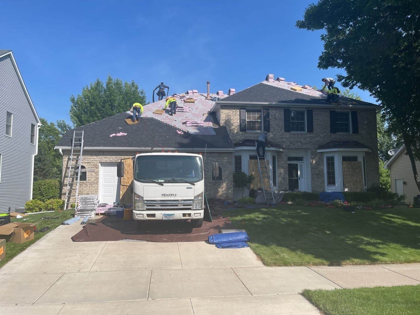 Crew tearing off a hail-damaged roof in Eden Prairie, MN