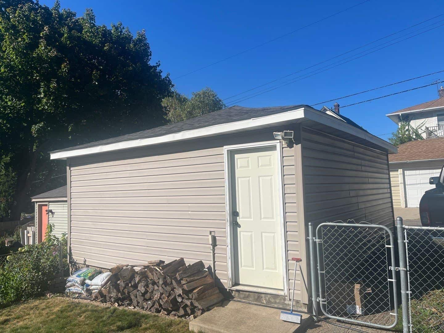 Detatched garage behind a Minneapolis, MN home with a matching new roof