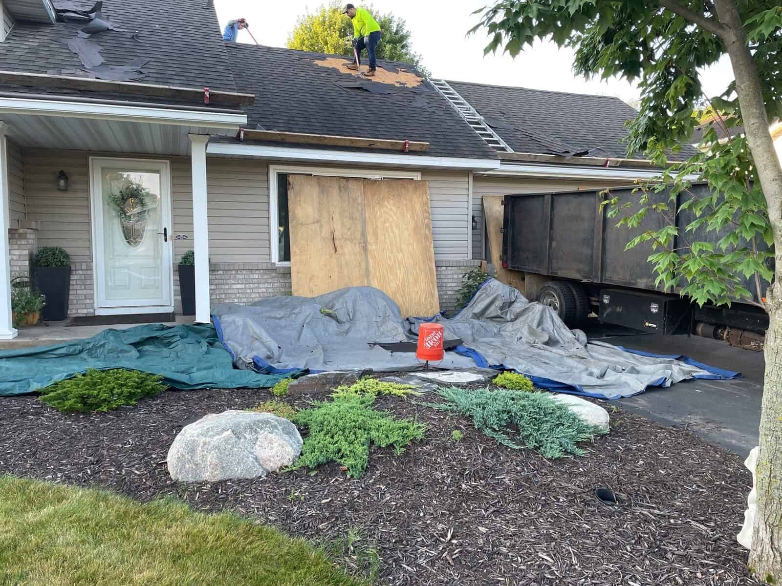 Windows and landscaping protected during an Andover, MN roof tear-off