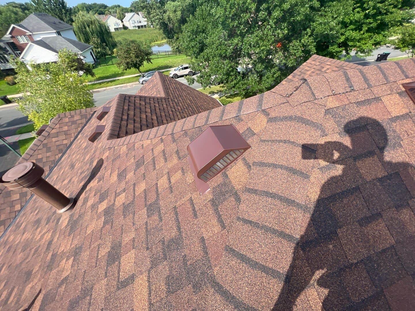 Ridge and vent detail of a Brownwood shingle roof in Osseo, MN