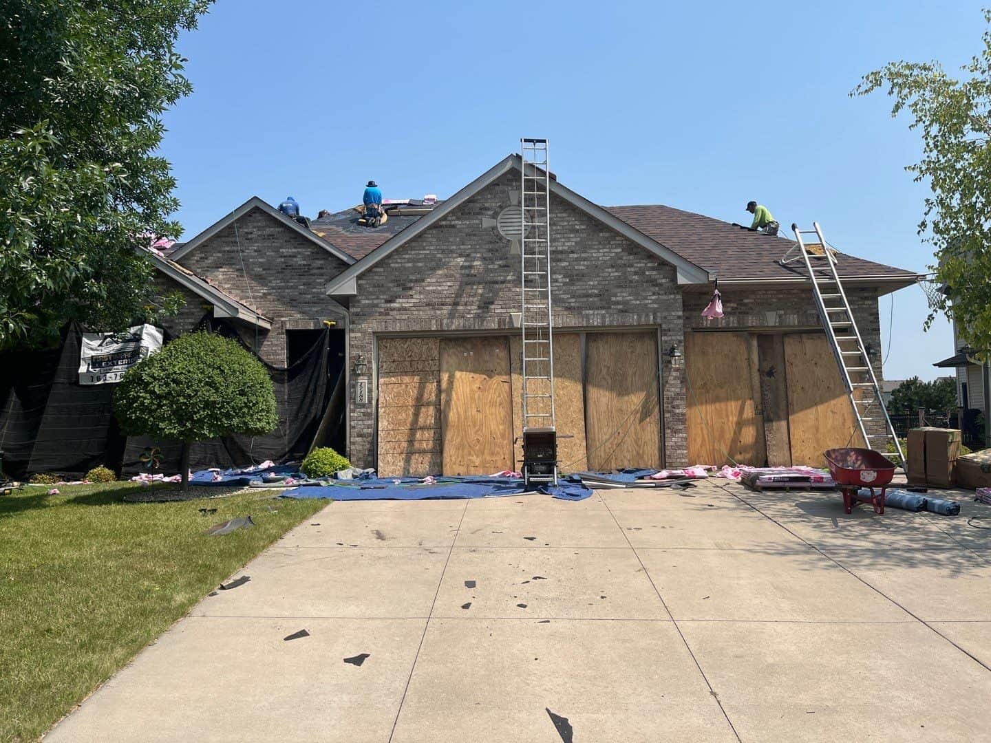 Garage protected with plywood during an Osseo, MN exterior replacement