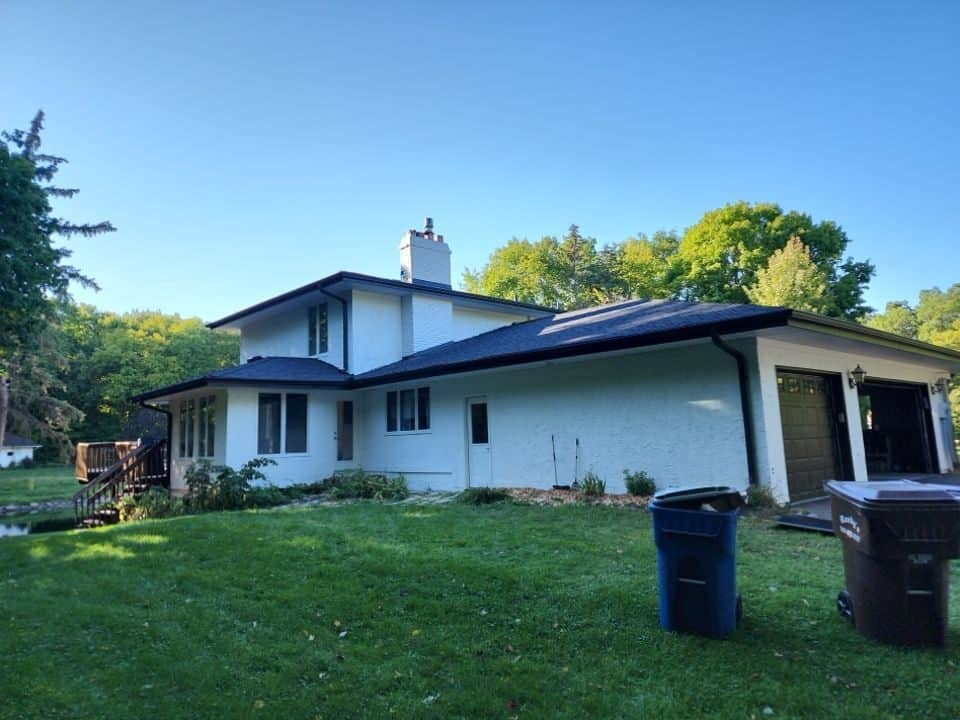 Rear view of new Onyx Black roof and black gutters on a Plymouth, MN home