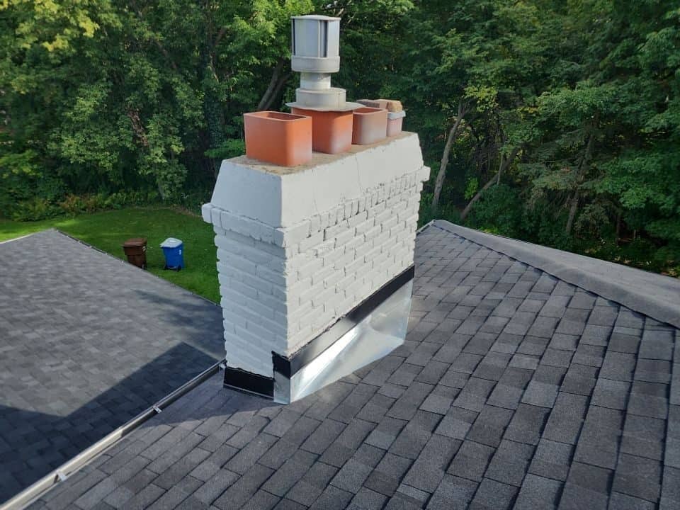 Chimney flashing detail on a new Onyx Black roof in Plymouth, MN