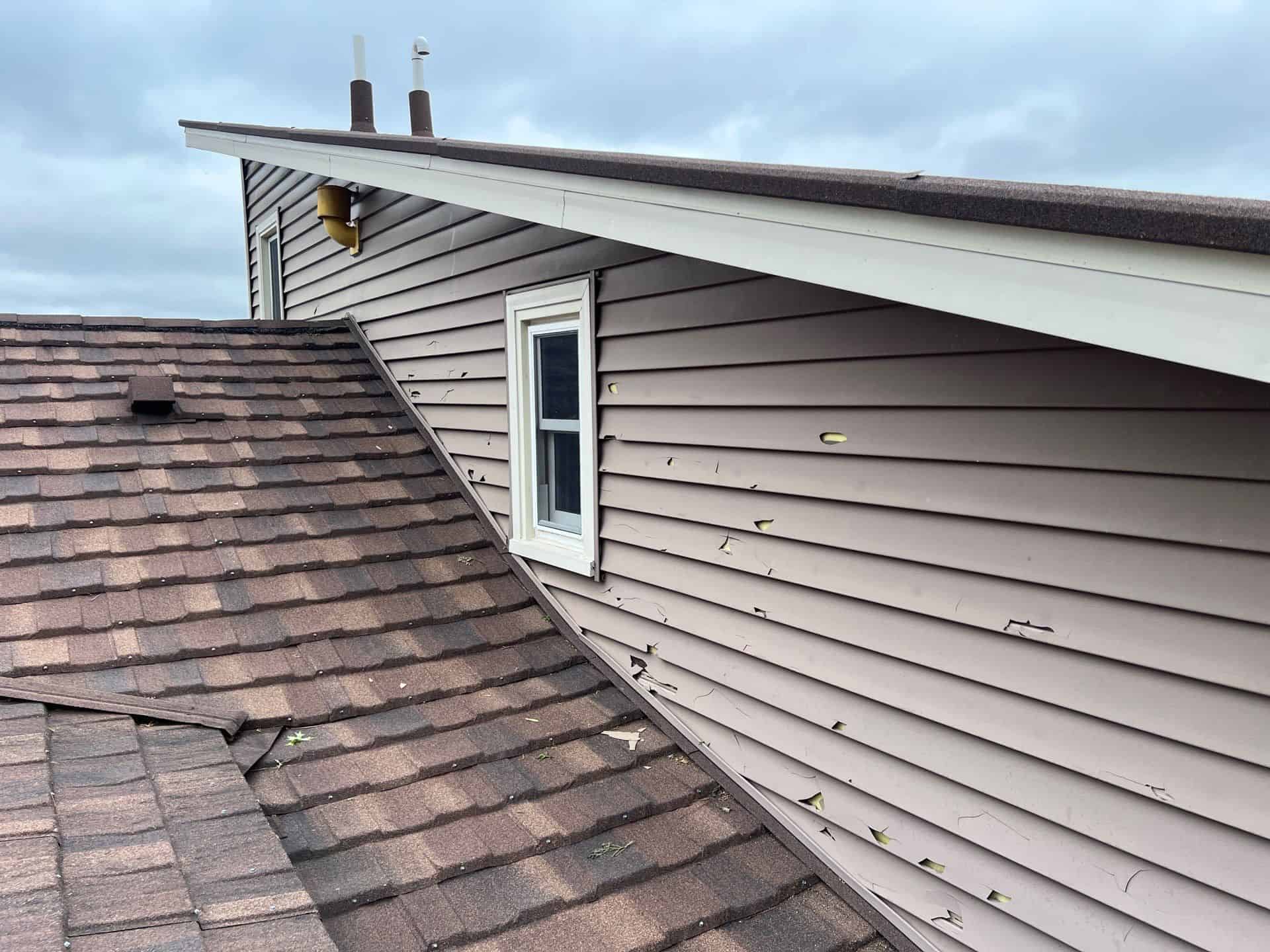 Hail hits marked on the old roof and siding during the inspection