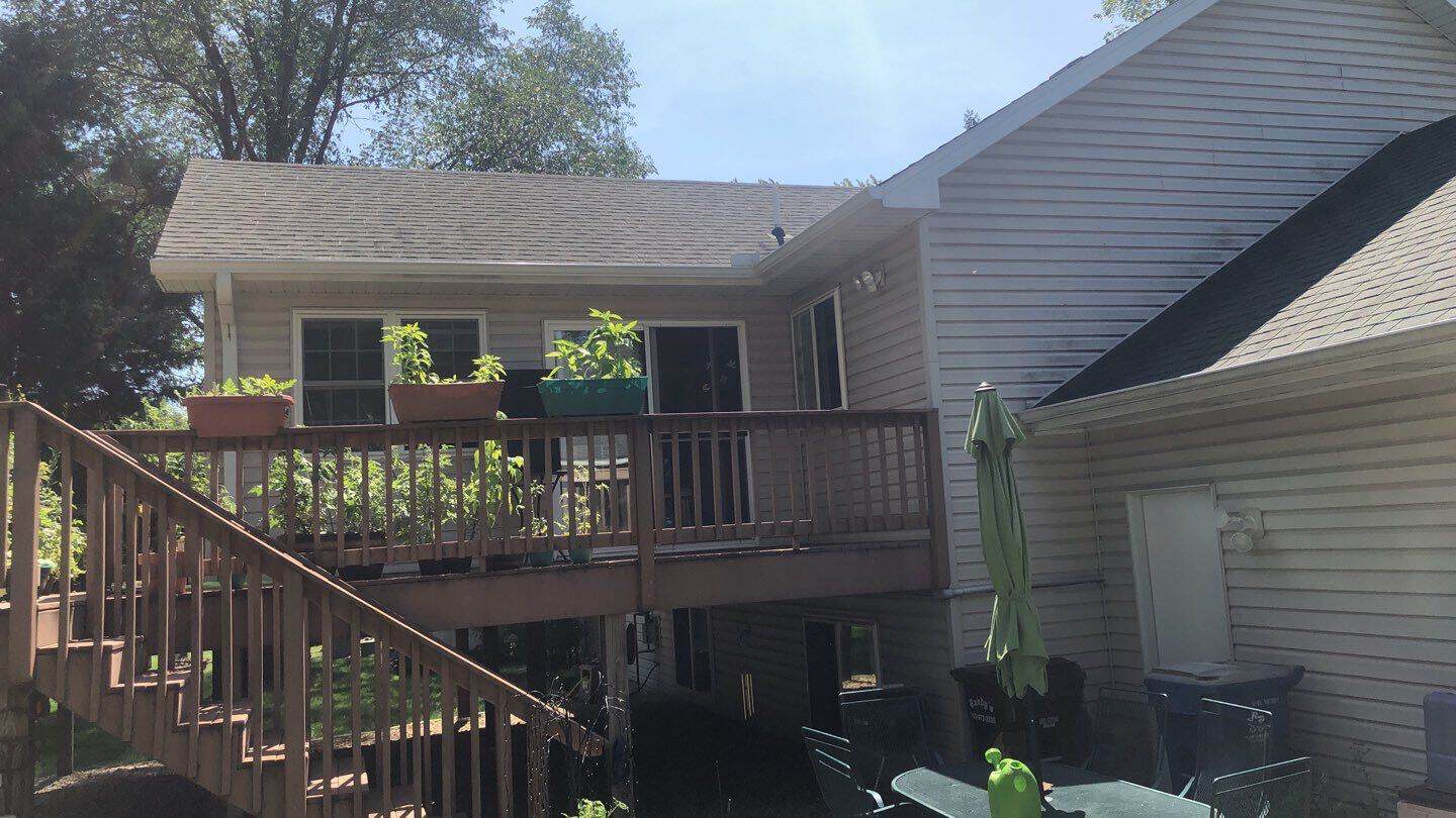 Back of a Wayzata, MN home with new gutters above the deck
