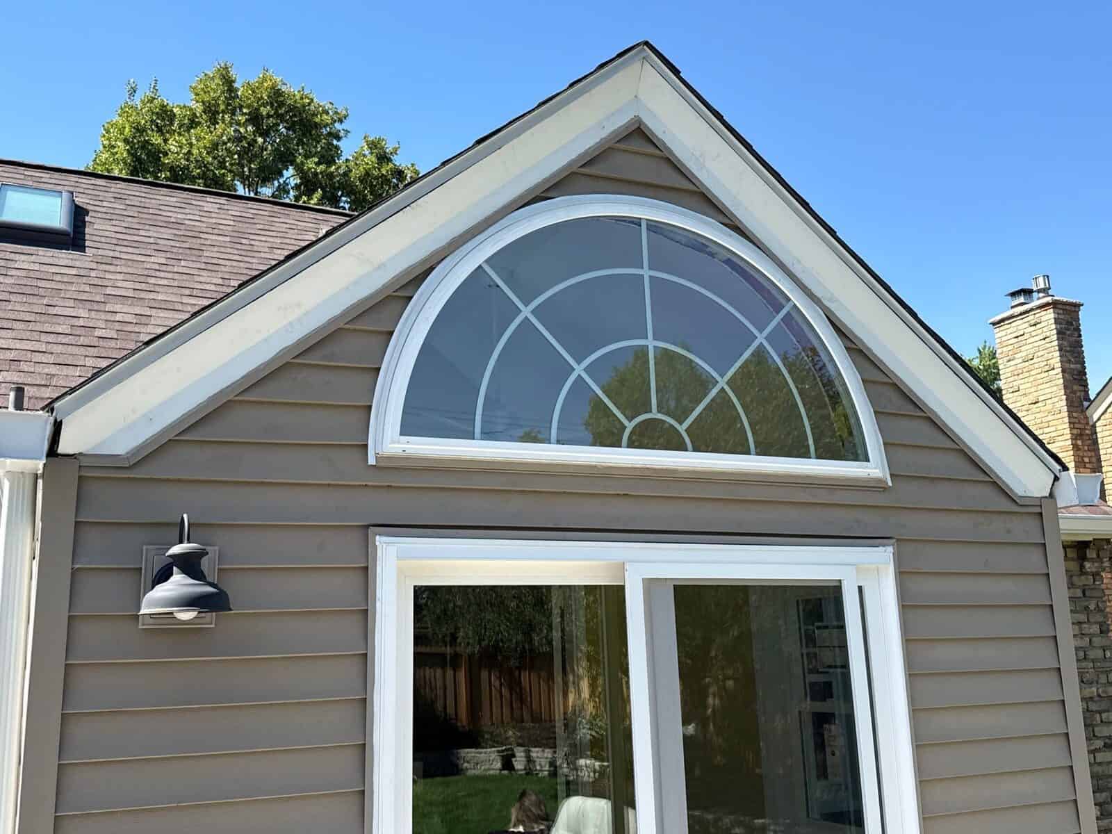 New Pella 250 Series arched window on a St. Louis Park, MN home with a Malarkey Vista roof