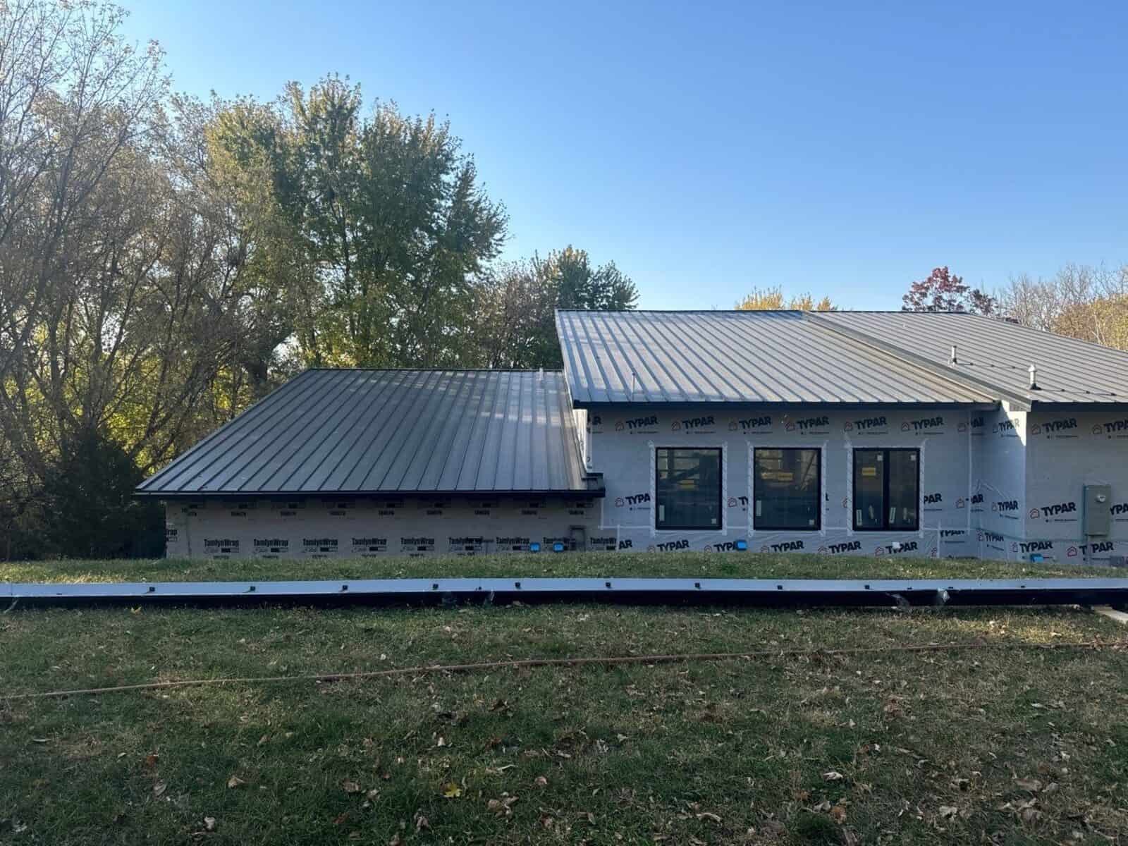 New standing seam metal roof on a Delano, MN home while siding work continues