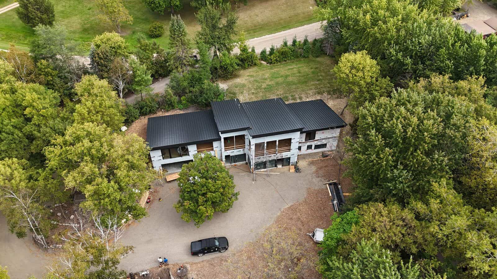 Aerial view of a Delano, MN home and its new metal roof from the tree line