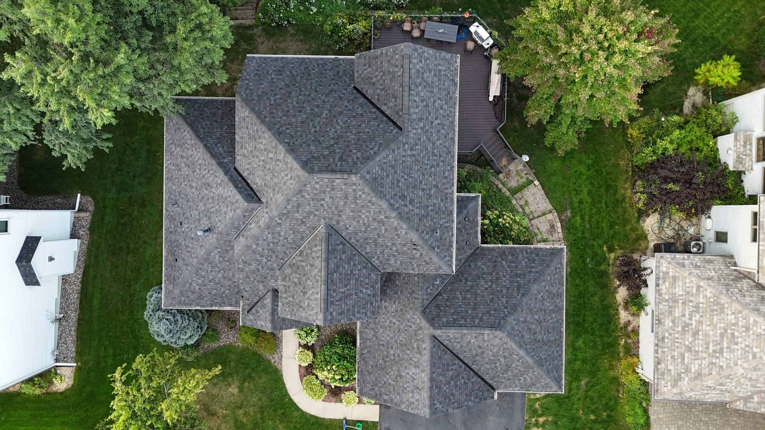 Aerial view of a completed large multi-plane shingle roof in Savage