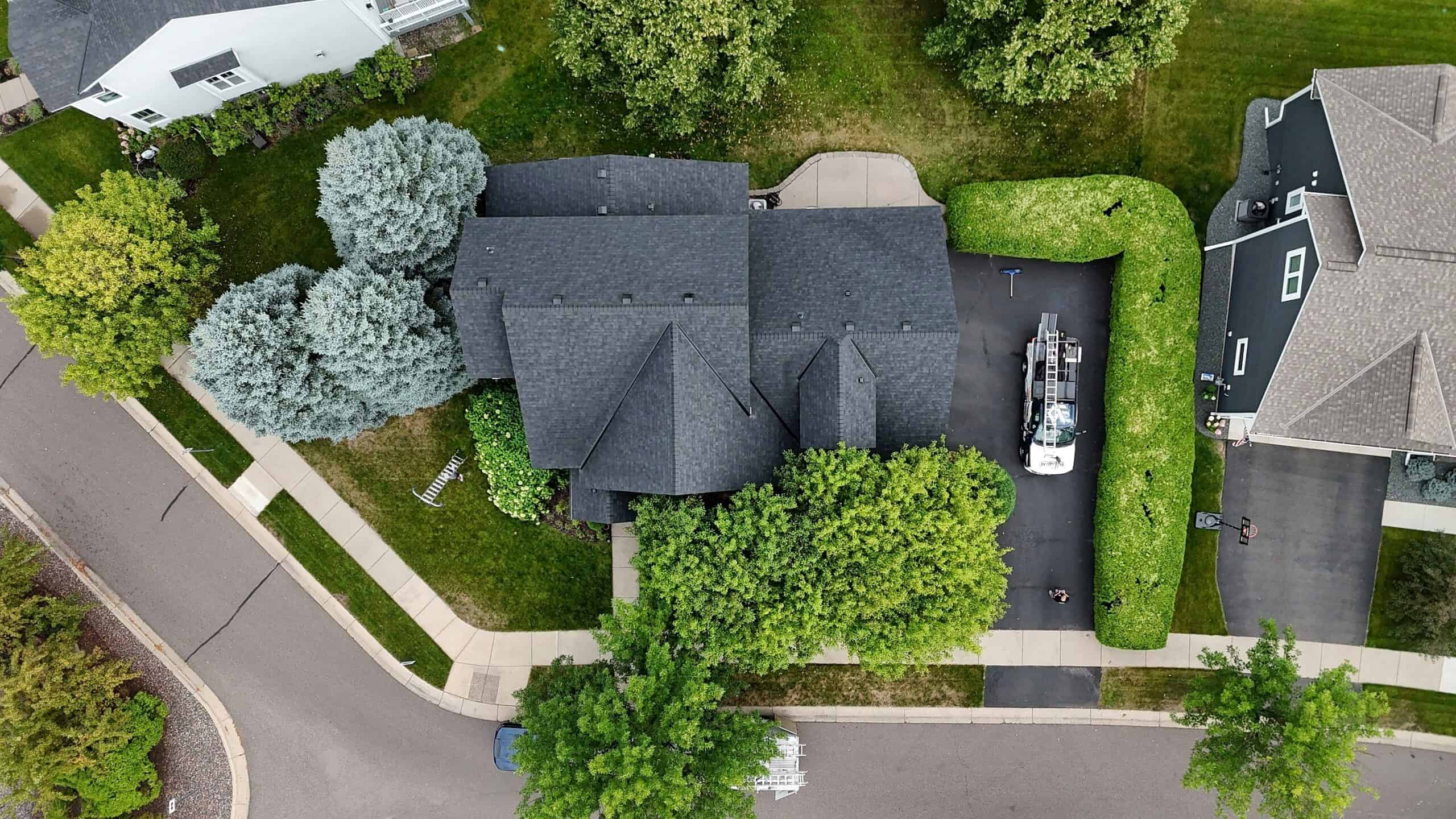 Overhead view of a completed dark shingle roof in Albertville