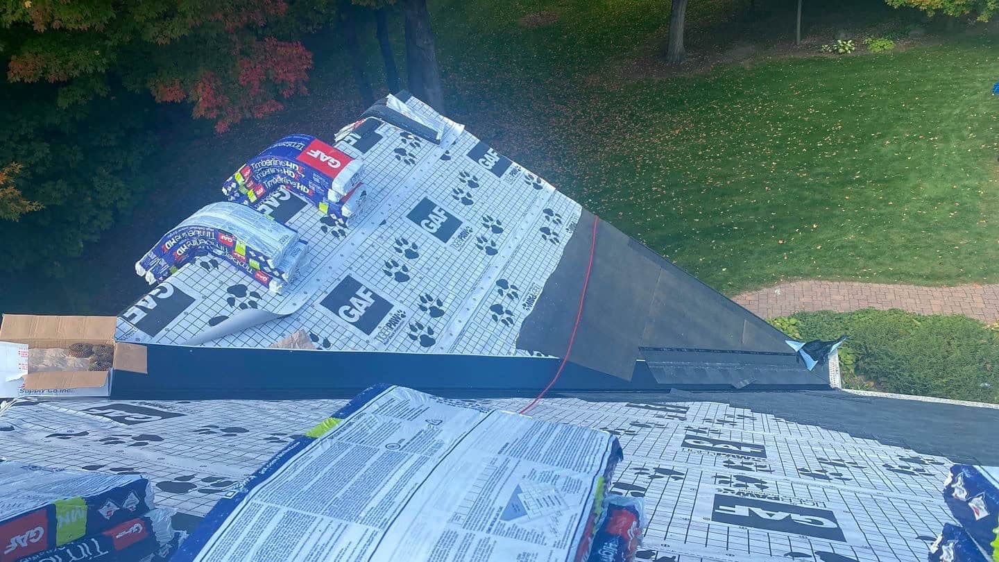 GAF TigerPaw synthetic underlayment and shingle bundles on a Rockford, MN roof during replacement