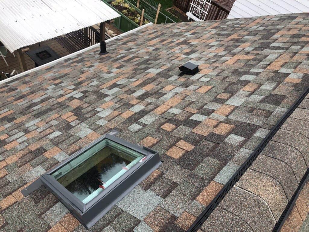New Velux skylight flashed into the finished Aged Copper shingle roof in St. Paul