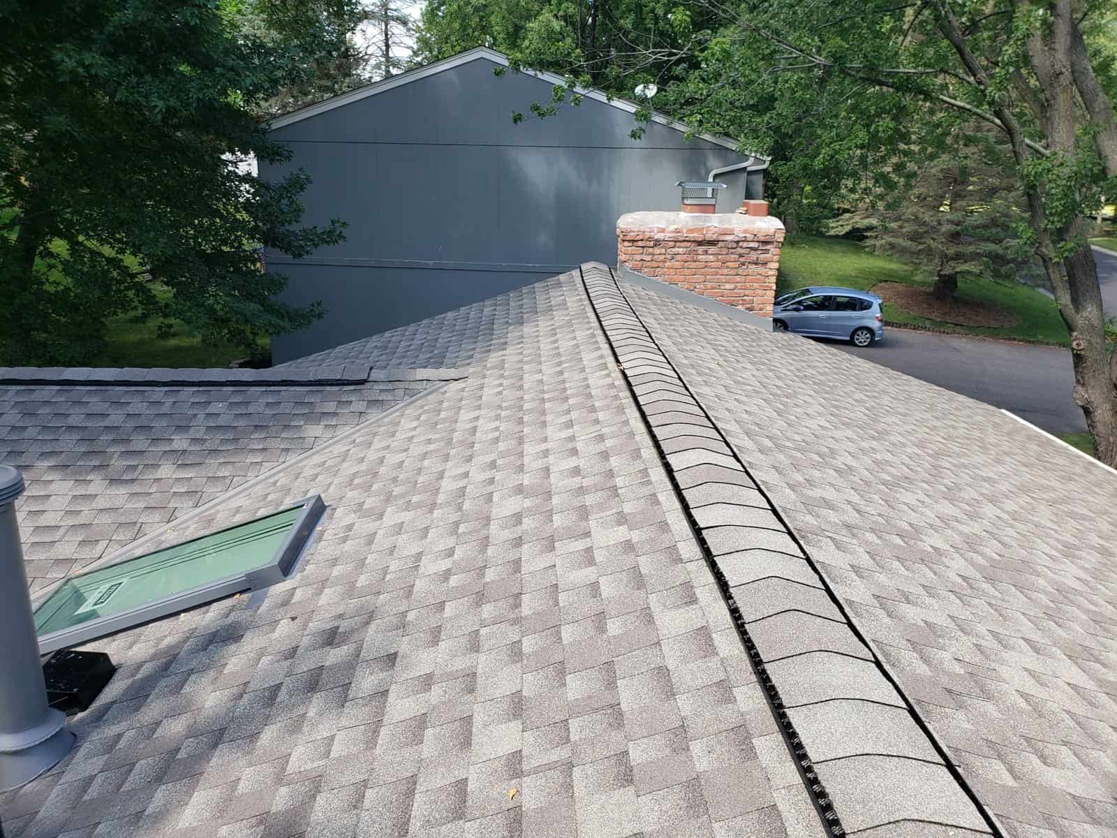 Completed GAF Timberline HDZ Weathered Wood roof and Velux fixed skylight in Eden Prairie, MN