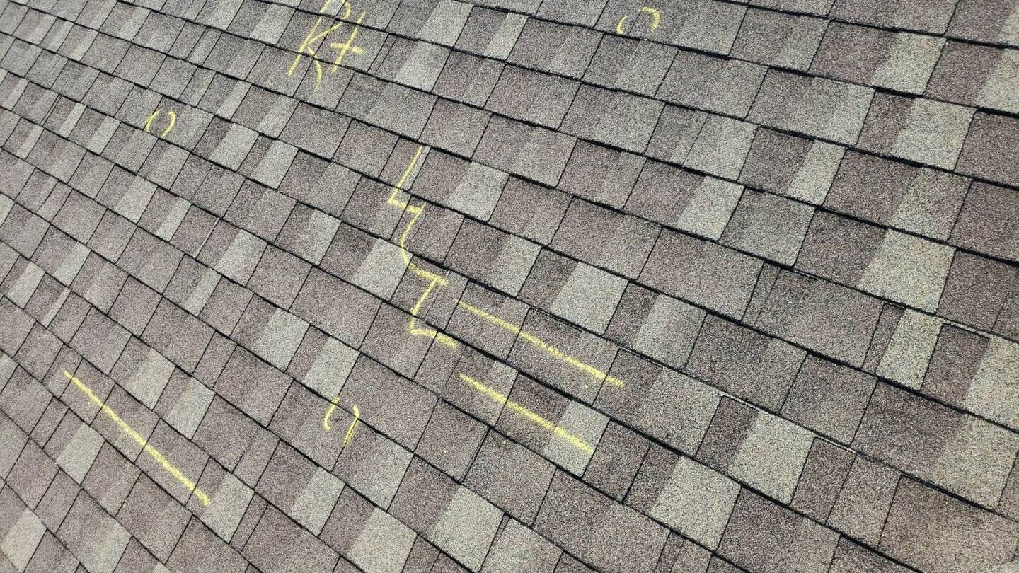Chalk-marked hail hits documented during the damage inspection